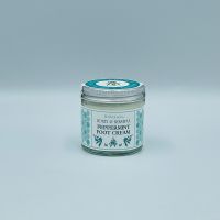 Screw top glass jar of honey and beeswax peppermint foot cream wrapped with a branded sticker, white background.